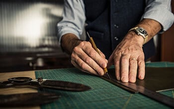 Man is using a ruler