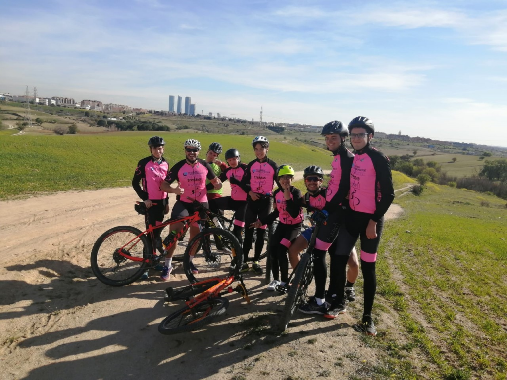A group of cyclists in pink clothes